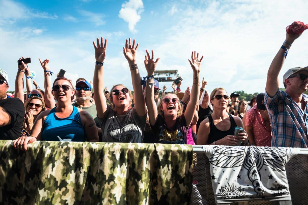 Enthusiastic concertgoers raise their hands in unison, enjoying the music and atmosphere in Williamson County, Tennessee.