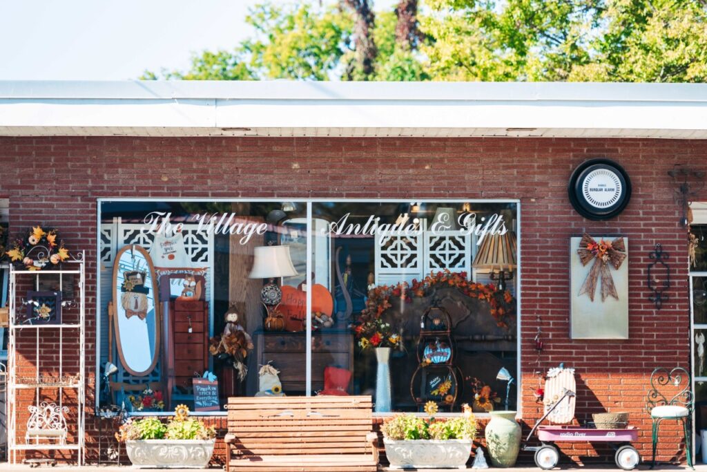 A charming antique shop with a rustic wooden bench and colorful fall decorations outside in Williamson County, Tennessee.