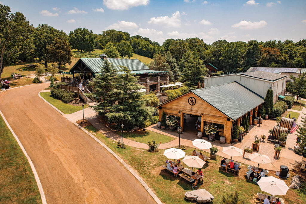 Aerial view of a rural outdoor venue with wooden structures, seating areas, and lush greenery in Williamson County, Tennessee.