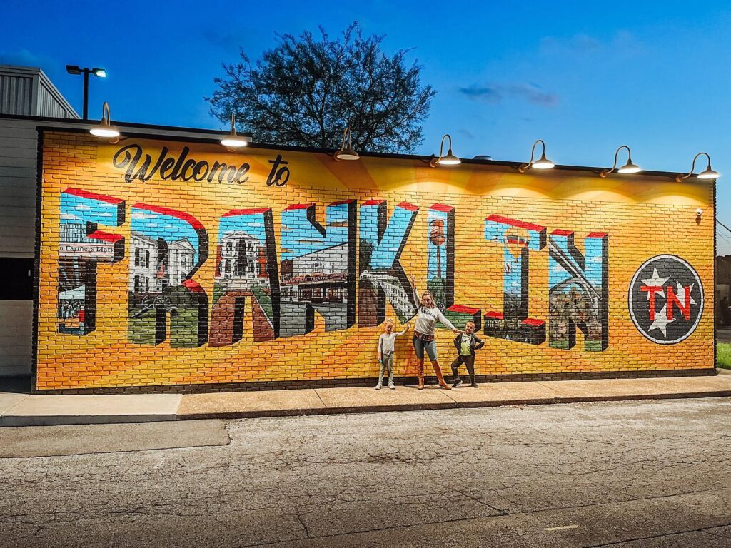 How to Spend the Perfect Weekend in Franklin A family stands in front of a colorful mural welcoming visitors to Franklin, TN in Williamson County, Tennessee.