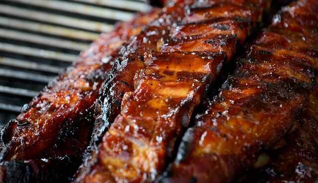 Grilled ribs with a glossy, caramelized bark, cooked to perfection on a barbecue in Williamson County, Tennessee.