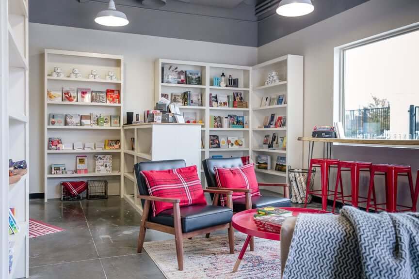 Modern bookstore with red accents, bookshelves, and comfortable seating area in Williamson County, Tennessee.