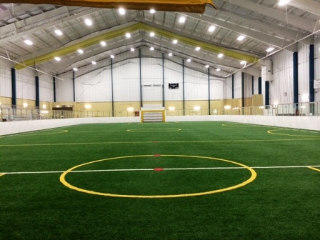 An indoor sports facility with a large artificial turf field and yellow markings in Williamson County, Tennessee.