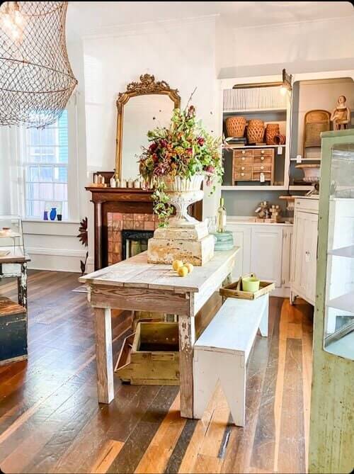 Rustic farmhouse interior with wooden table, white bench, and vintage decor in Williamson County, Tennessee.