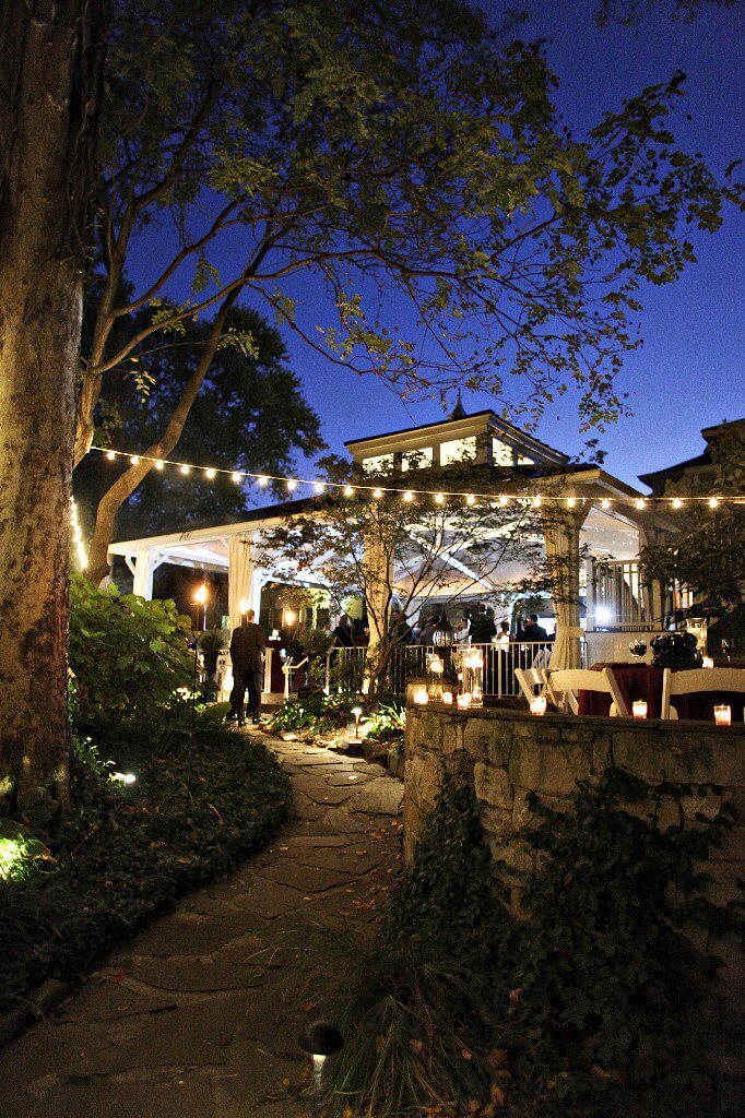 Evening garden party with string lights, stone path, and gazebo in Williamson County, Tennessee.