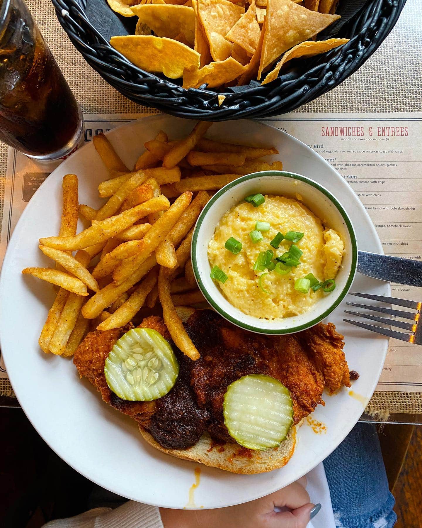 A plate of crispy fried chicken with pickles, mashed potatoes, and french fries in Williamson County, Tennessee.