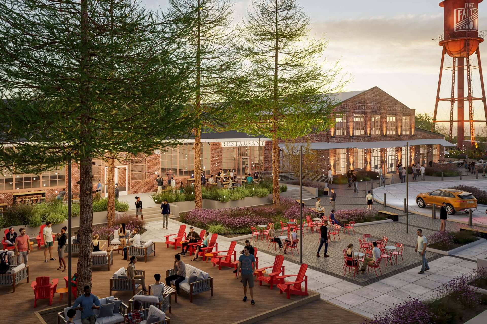 Outdoor dining area with red chairs, surrounded by greenery and a historic water tower in Williamson County, Tennessee.