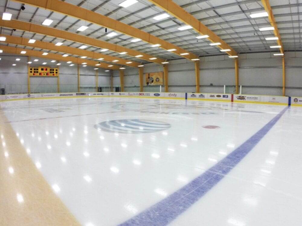 A large indoor ice rink with a smooth white surface and blue markings in Williamson County, Tennessee.