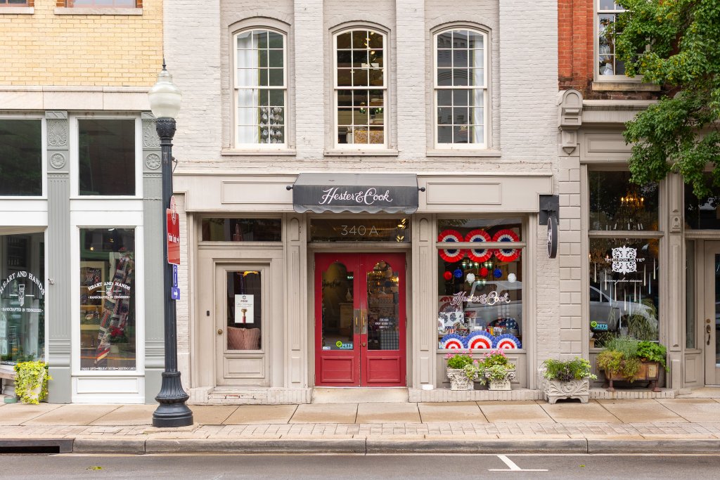 A charming storefront with red doors and patriotic decorations on a quaint street in Williamson County, Tennessee.