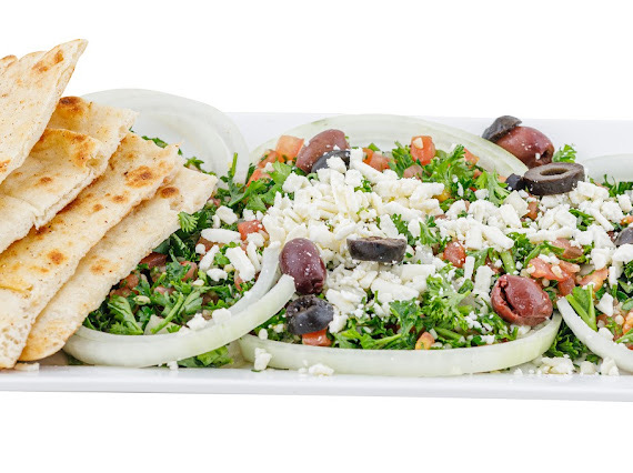A plate of tabbouleh salad with pita bread, topped with olives and feta cheese in Williamson County, Tennessee.