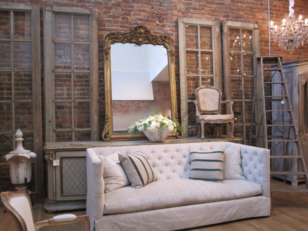Elegant living room with white tufted sofa, antique mirror, and vintage chandelier in Williamson County, Tennessee.