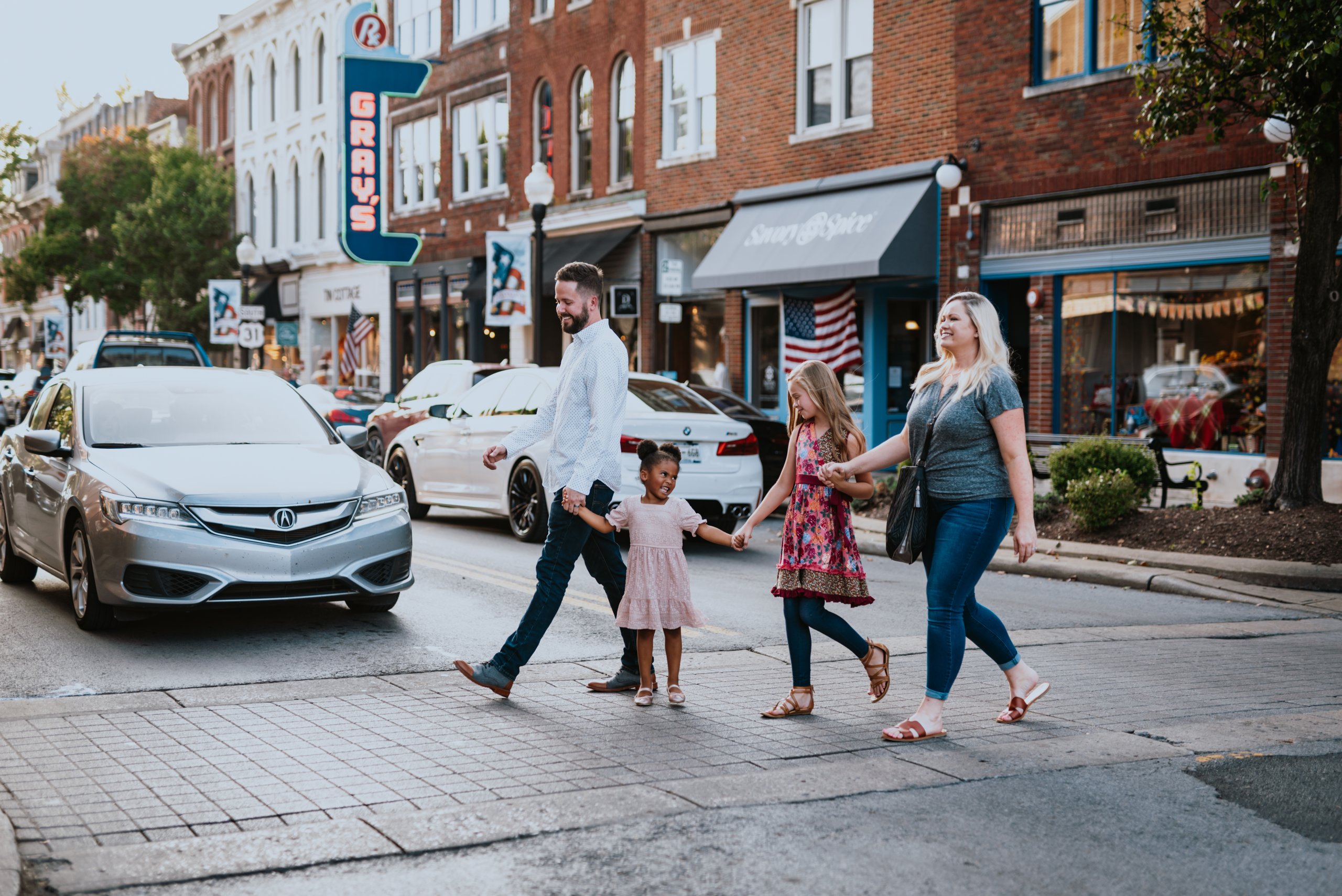 Downtown Franklin: Explore the City's Great American Main Street A family of four, including a young girl, crosses a busy street in a small town in Williamson County, Tennessee.