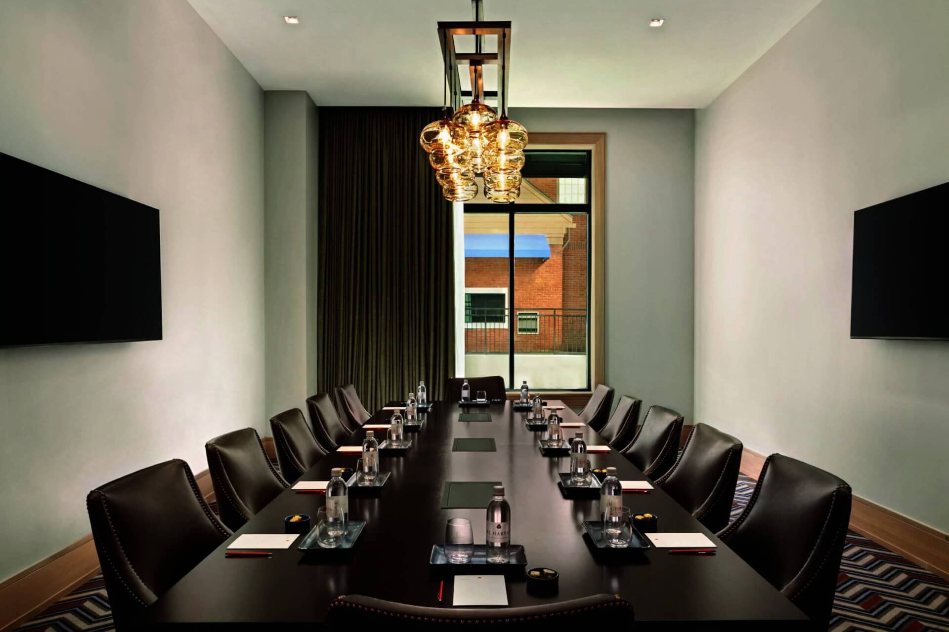 A modern conference room with a long table, leather chairs, and large windows in Williamson County, Tennessee.