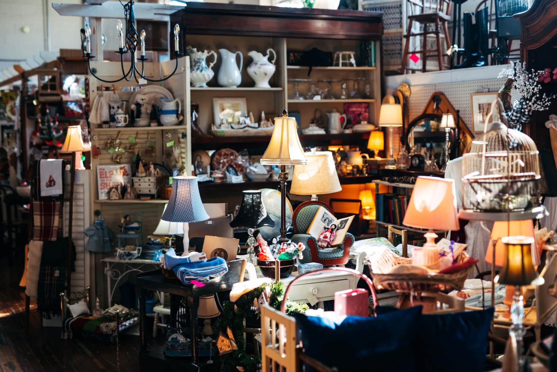 A cluttered antique shop filled with vintage furniture, lamps, and decorative items in Williamson County, Tennessee.