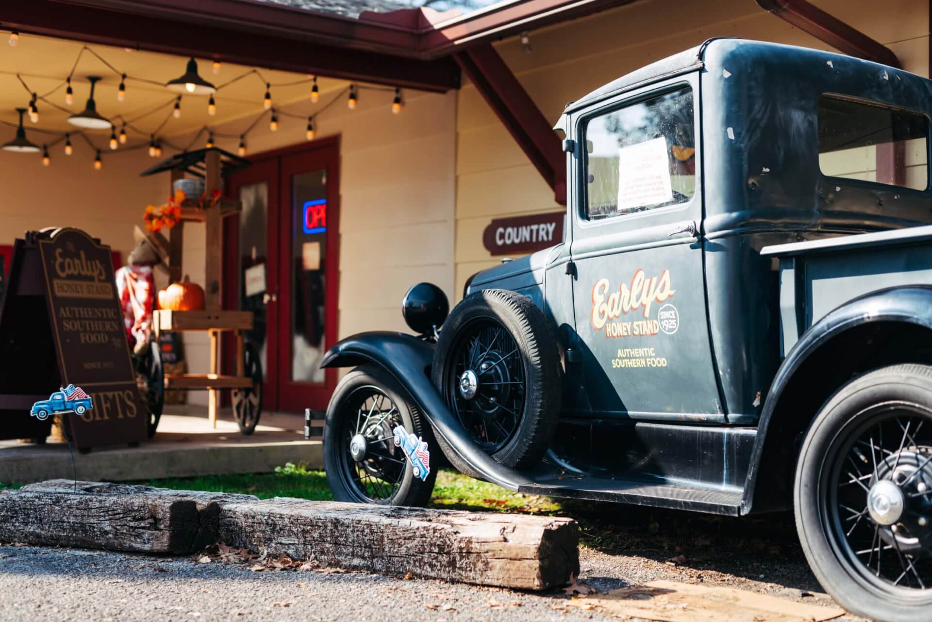 Vintage pickup truck parked outside a quaint country store with autumn decorations in Williamson County, Tennessee.