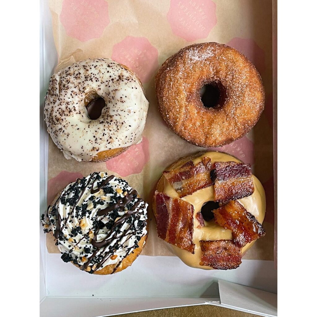 Four unique donuts with various toppings and glazes in a box in Williamson County, Tennessee.