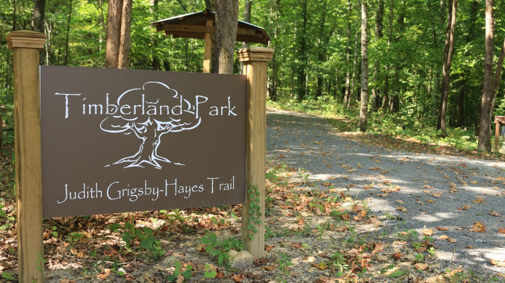 A wooden sign marks the entrance to Timberland Park's Judith Griggsby-Hayes Trail in Williamson County, Tennessee.