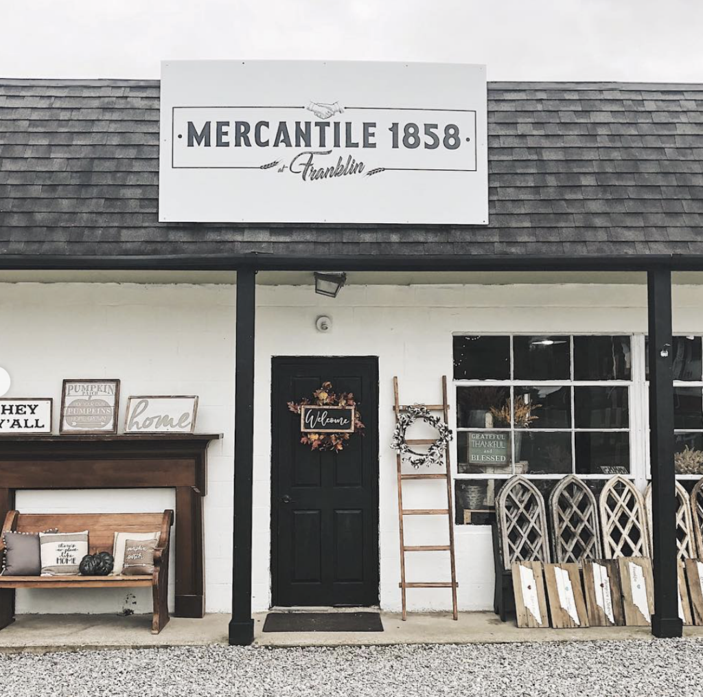 A quaint shop with a black door and white sign reading 'Mercantile 1858' above it in Williamson County, Tennessee.